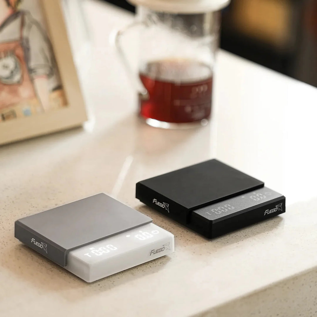 "Compact digital coffee scale with precise 0.1g measurement, black sleek design, clear LCD display for coffee brewing."