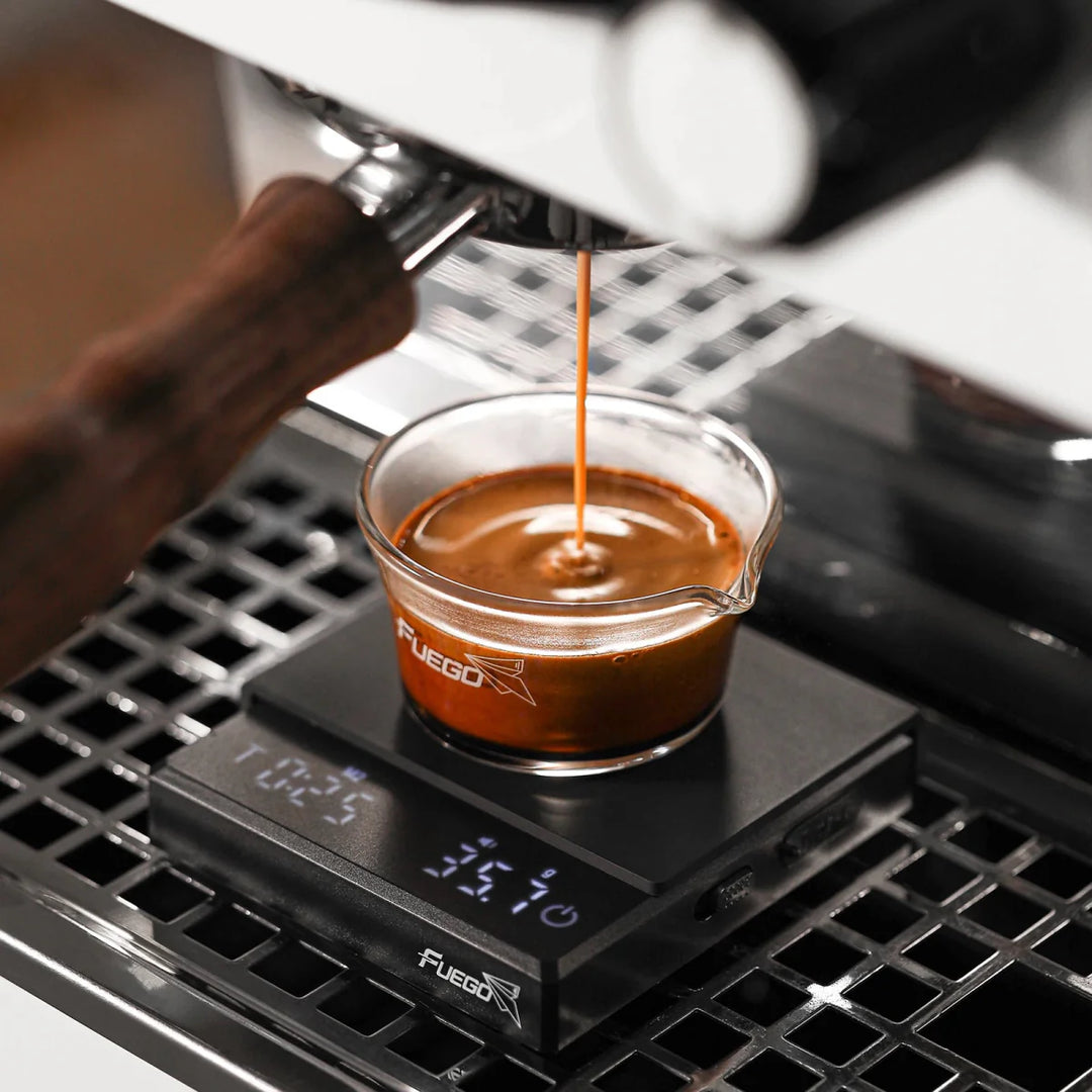 "Compact digital coffee scale with precise 0.1g measurement, black sleek design, clear LCD display for coffee brewing."
