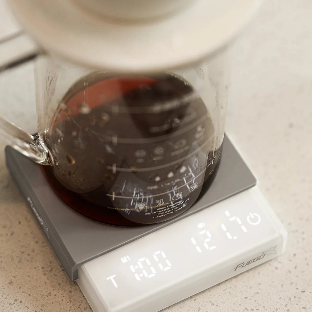 "Compact digital coffee scale with precise 0.1g measurement, black sleek design, clear LCD display for coffee brewing."