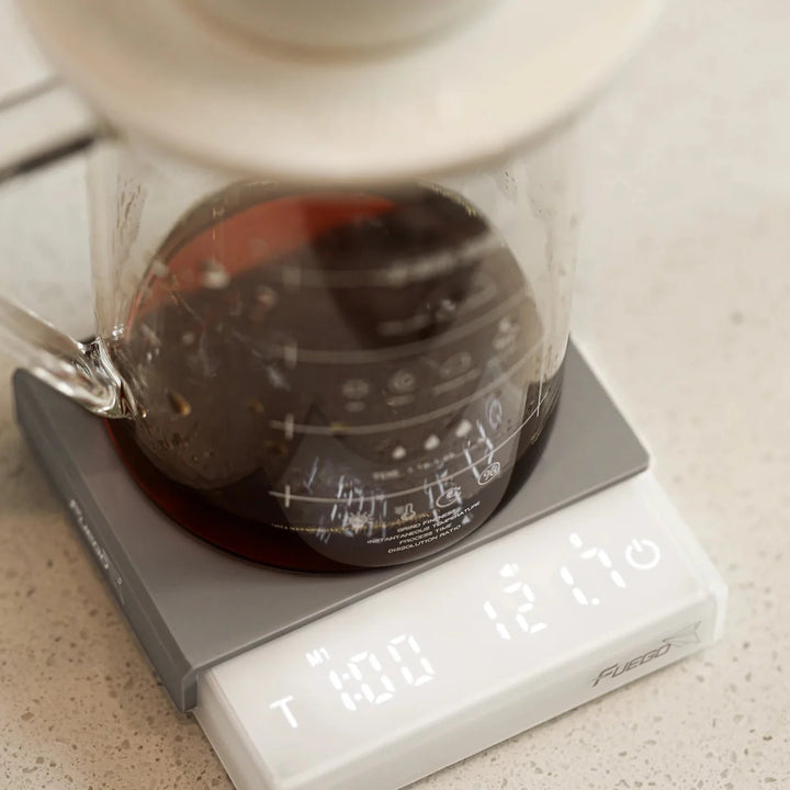 "Compact digital coffee scale with precise 0.1g measurement, black sleek design, clear LCD display for coffee brewing."