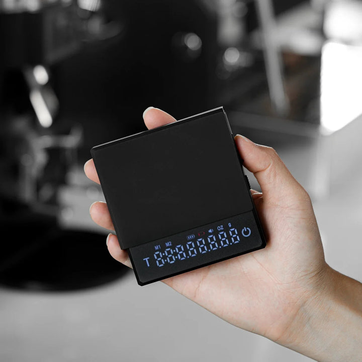 "Compact digital coffee scale with precise 0.1g measurement, black sleek design, clear LCD display for coffee brewing."