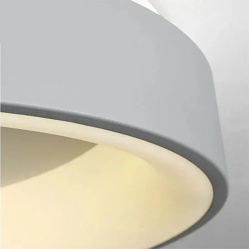 Contemporary circular metal LED ceiling light, sleek design with acrylic finish, emits soft warm or cool lighting for home de