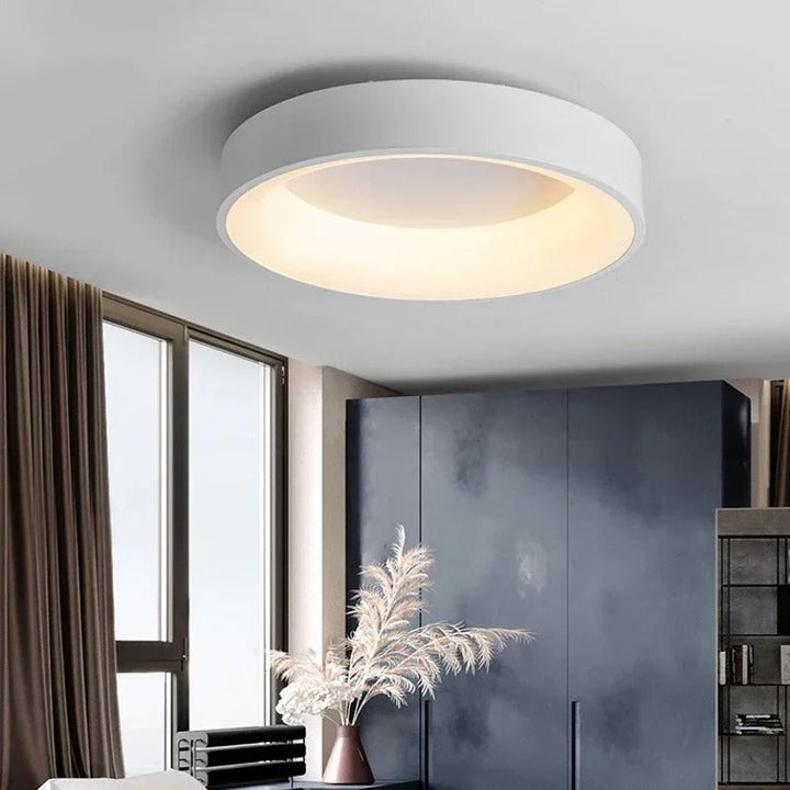 Contemporary circular metal LED ceiling light, sleek design with acrylic finish, emits soft warm or cool lighting for home de