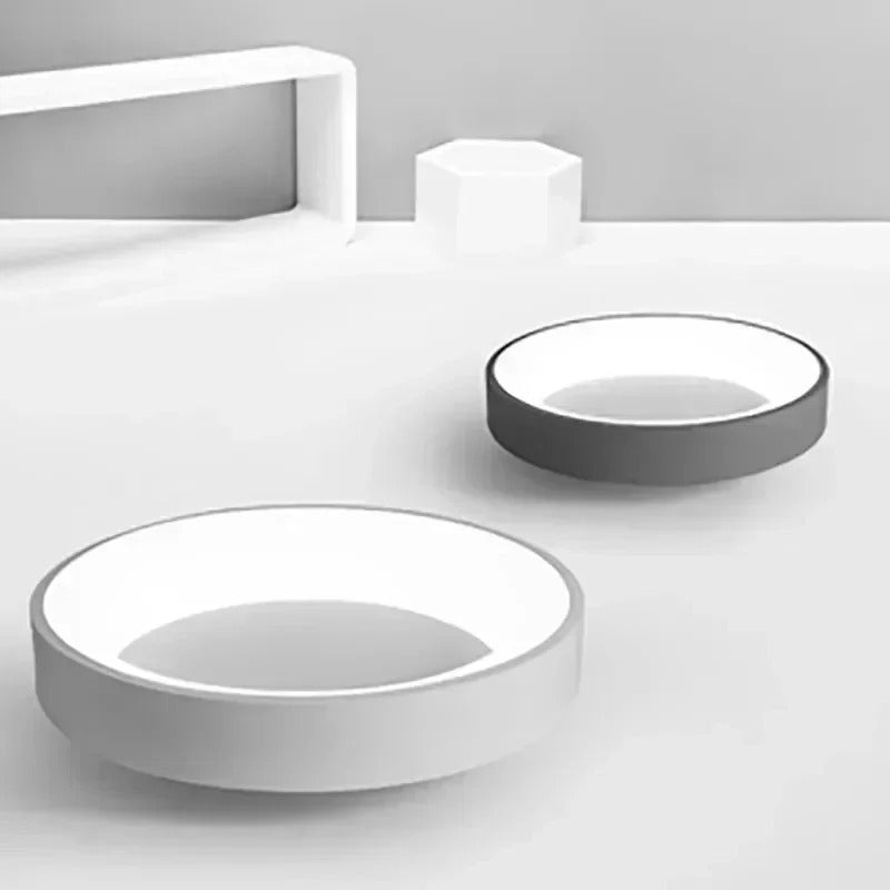 Contemporary circular metal LED ceiling light, sleek design with acrylic finish, emits soft warm or cool lighting for home de