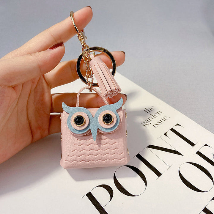 Group of colorful mini handbag keychains (pink, blue, yellow) showcasing variety and style