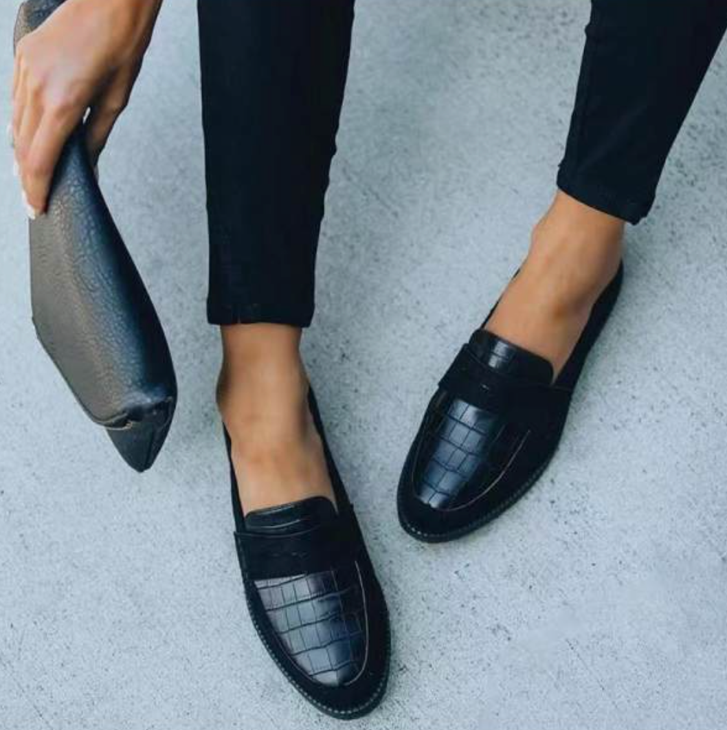 Elegant black women's croc-embossed slip-on loafers, perfect for versatile fashion and everyday comfort.