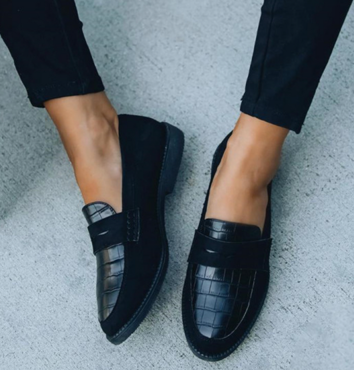 Classic black croc-embossed slip-on loafers for women, offering an elegant style and versatile comfort.