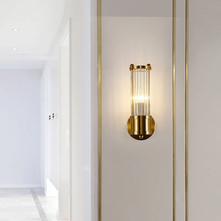 "Elegant cylindrical glass wall light in gold or chrome with modern design, ideal for enhancing any room's ambiance."