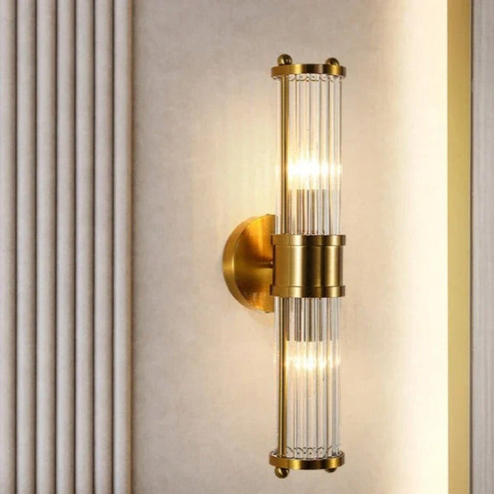 "Elegant cylindrical glass wall light in gold or chrome with modern design, ideal for enhancing any room's ambiance."