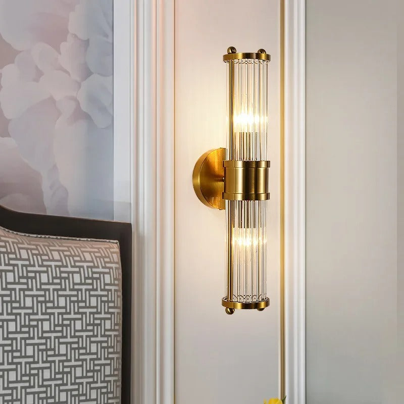 "Elegant cylindrical glass wall light in gold or chrome with modern design, ideal for enhancing any room's ambiance."