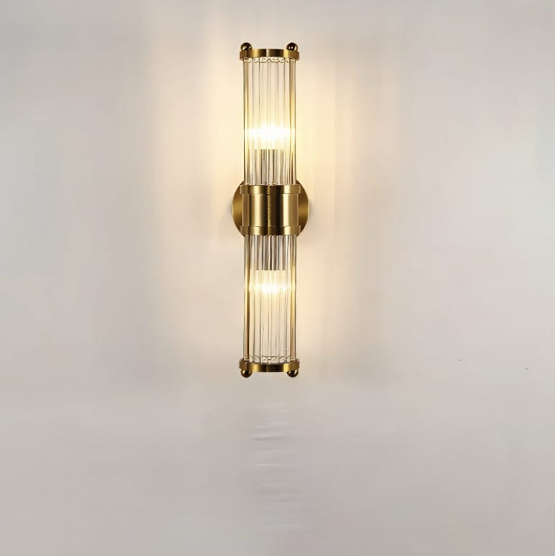"Elegant cylindrical glass wall light in gold or chrome with modern design, ideal for enhancing any room's ambiance."