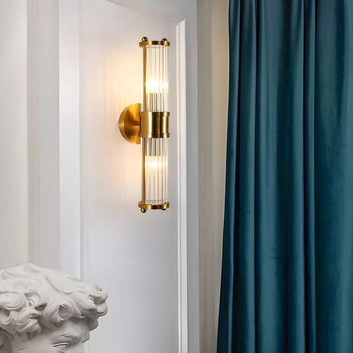 "Elegant cylindrical glass wall light in gold or chrome with modern design, ideal for enhancing any room's ambiance."