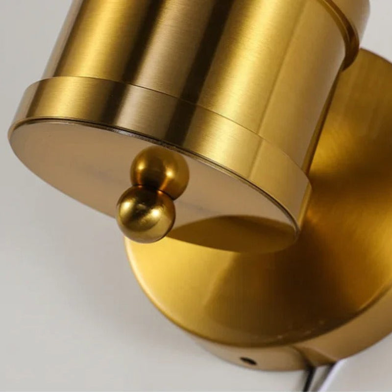 "Elegant cylindrical glass wall light in gold or chrome with modern design, ideal for enhancing any room's ambiance."
