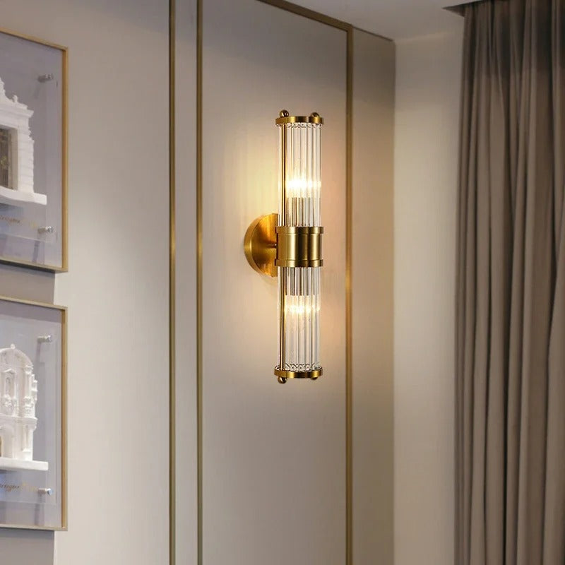 "Elegant cylindrical glass wall light in gold or chrome with modern design, ideal for enhancing any room's ambiance."