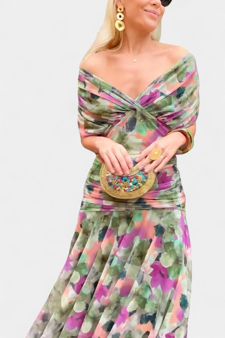 Women's elegant floral maxi dress with a gracefully flowing skirt and chic pleated waist design.