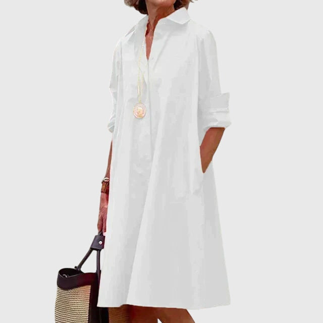 Graceful back view of a women's elegant flowy dress. Comfortable, casual summer dress with a beautiful drape.