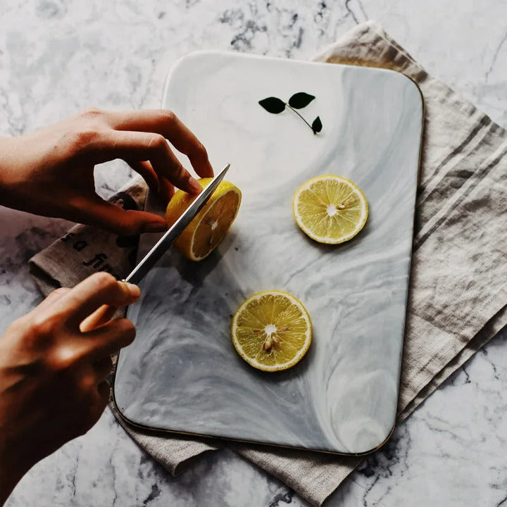 Elegant marble cutting board with polished finish, ideal for gourmet cooking and kitchen elegance, rectangular 10x16 inches.