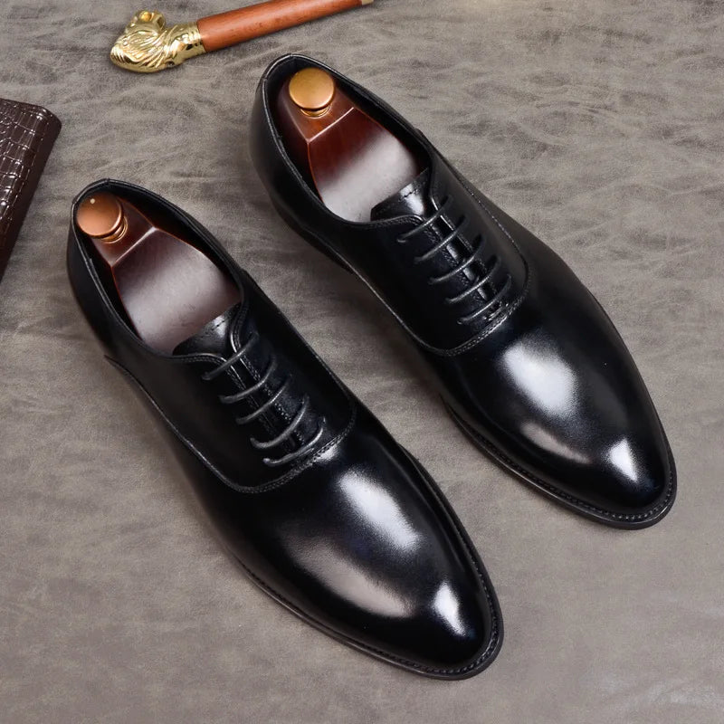 Versatile men's black leather Oxford dress shoes. Ideal for formal wear, business, or elegant wedding attire. Comfortable fit.