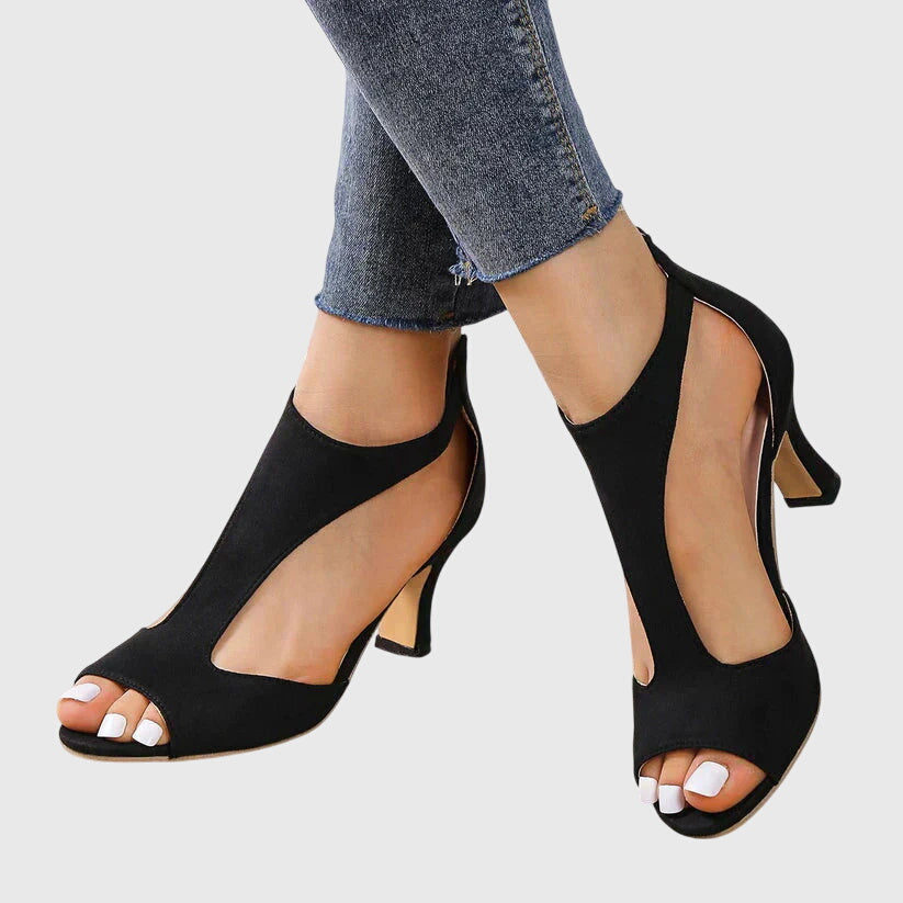 Close-up of a high-heeled women's shoe featuring a strappy design and an open toe