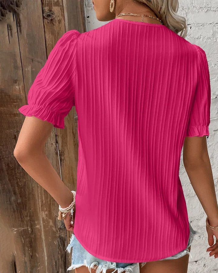 Stylish women's short sleeve V-neck top in white lace, offering a chic and elegant look