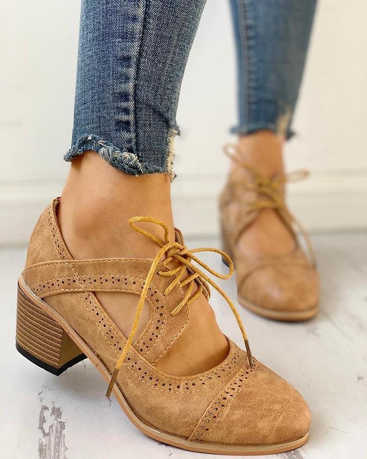 Fashionable women's heeled black lace-up T-strap dress shoes, offering comfort and sophistication.
