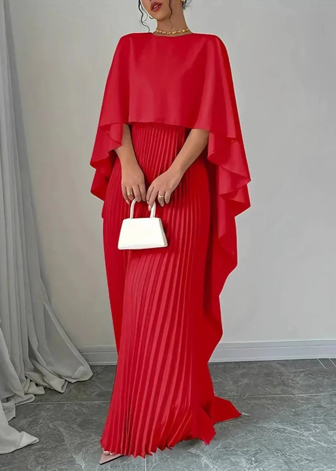Chic women's cape overlay pleated maxi dress, an elegant formal evening gown for special black tie occasions.