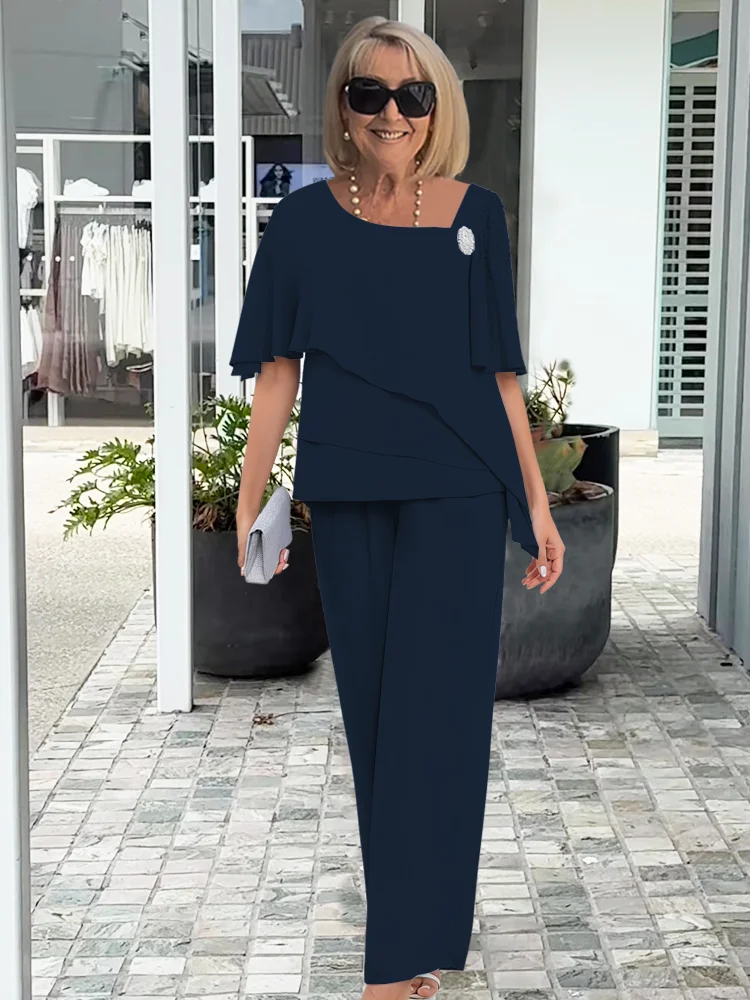 Stylish women's cape top and straight leg trousers two-piece set. Comfortable & elegant for occasion wear.