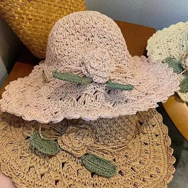 Women's stylish straw sun hat featuring intricate crochet work and a delicate ruffle trim.