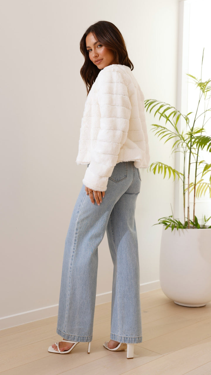 Fashionable women's evening jacket, short and sassy, featuring soft faux fur.