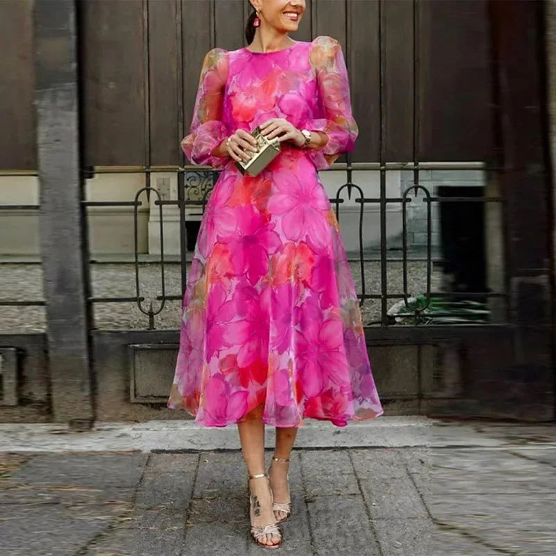 Elegant women's floral midi dress with long sheer sleeves, perfect for a wedding guest or special occasion party.