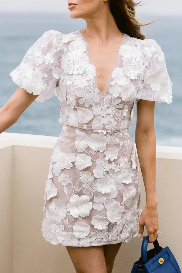 Chic women's mini dress featuring a vibrant floral print & stylish puff sleeves, ideal for party wear.