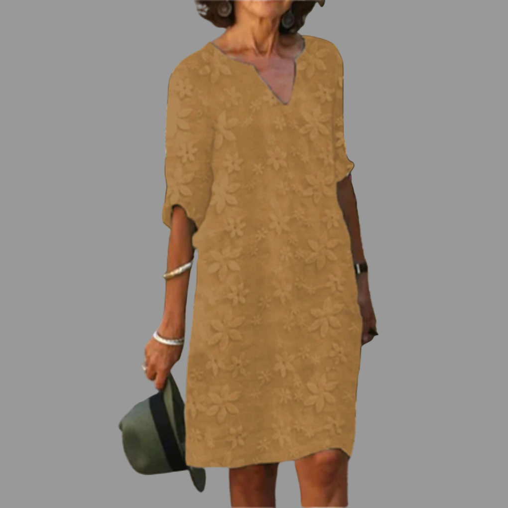 Relaxed fit women's floral V-neck midi dress. Elegant and airy, perfect for warm weather or versatile occasion styling.