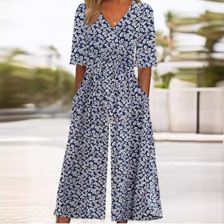 Comfortable elegant women's floral wide-leg jumpsuit with V-neck and elbow sleeves, ideal for summer resort wear.