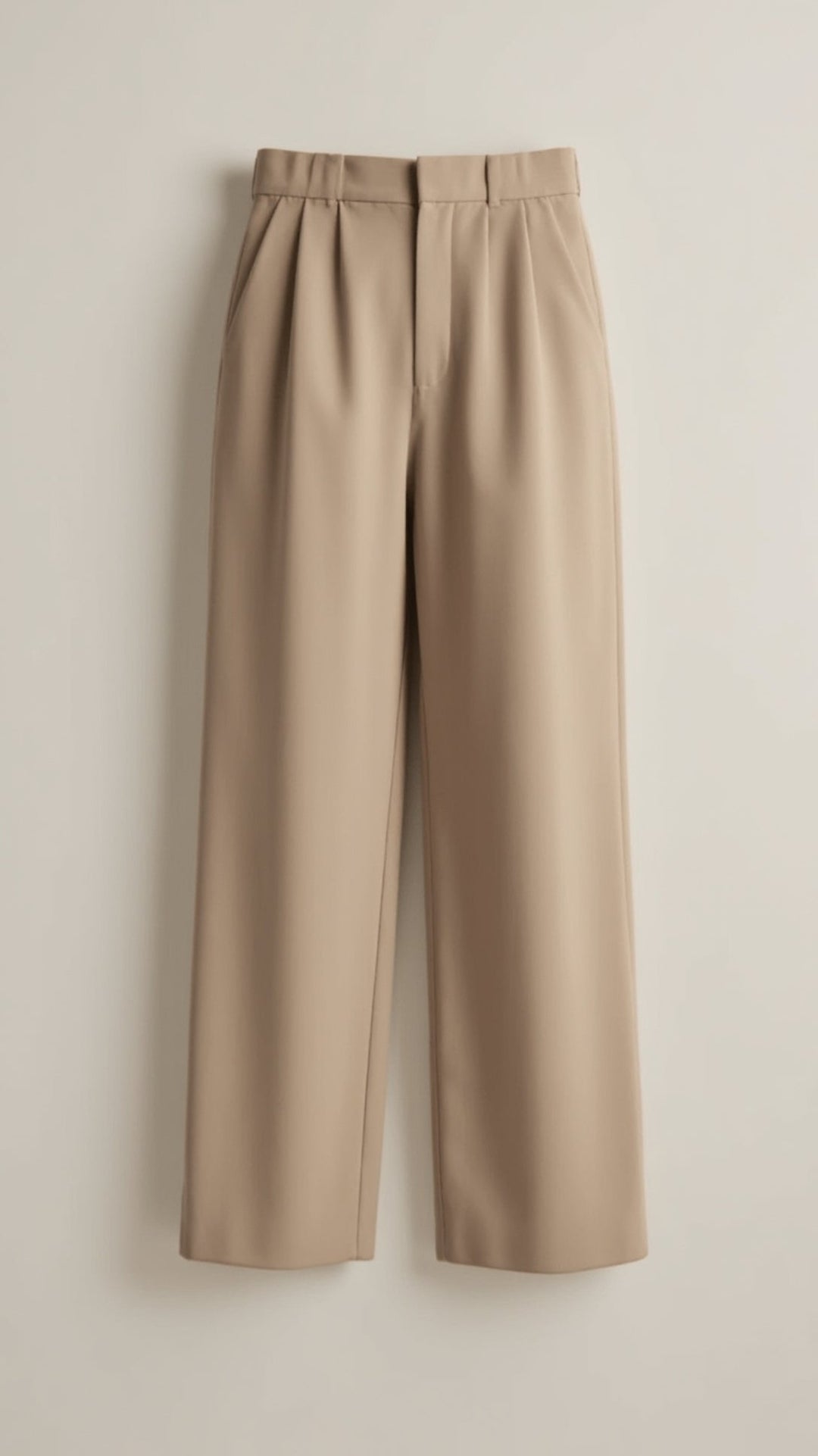 Studio shot of women's high-waist wide-leg pants against a plain background, highlighting their details.