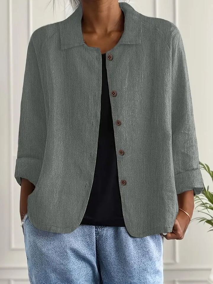 Relaxed fit women's elegant long sleeve button-up blouse. A sophisticated and stylish top with an open collar.