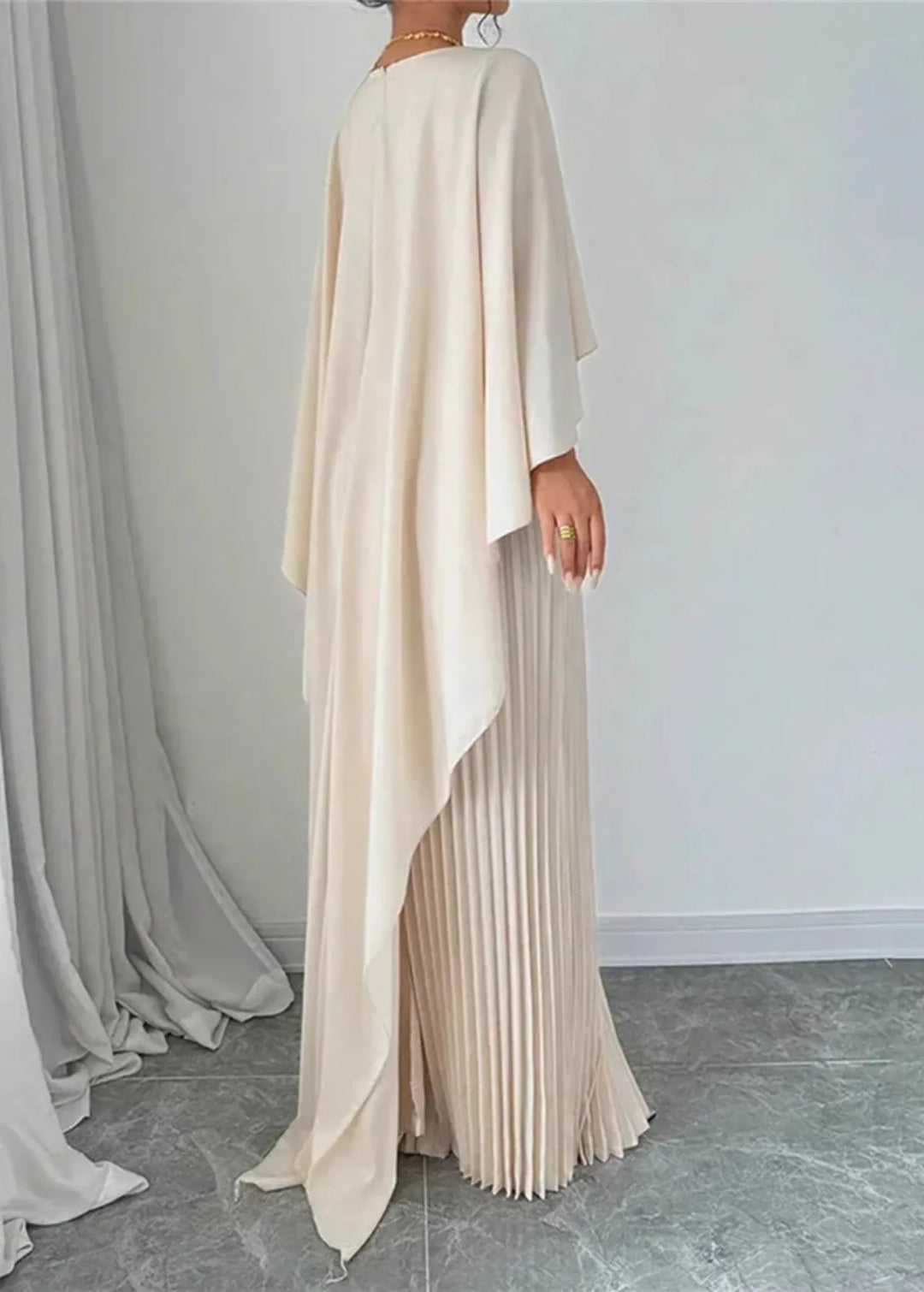 Formal women's long pleated dress featuring a chic cape overlay, ideal for special occasions.