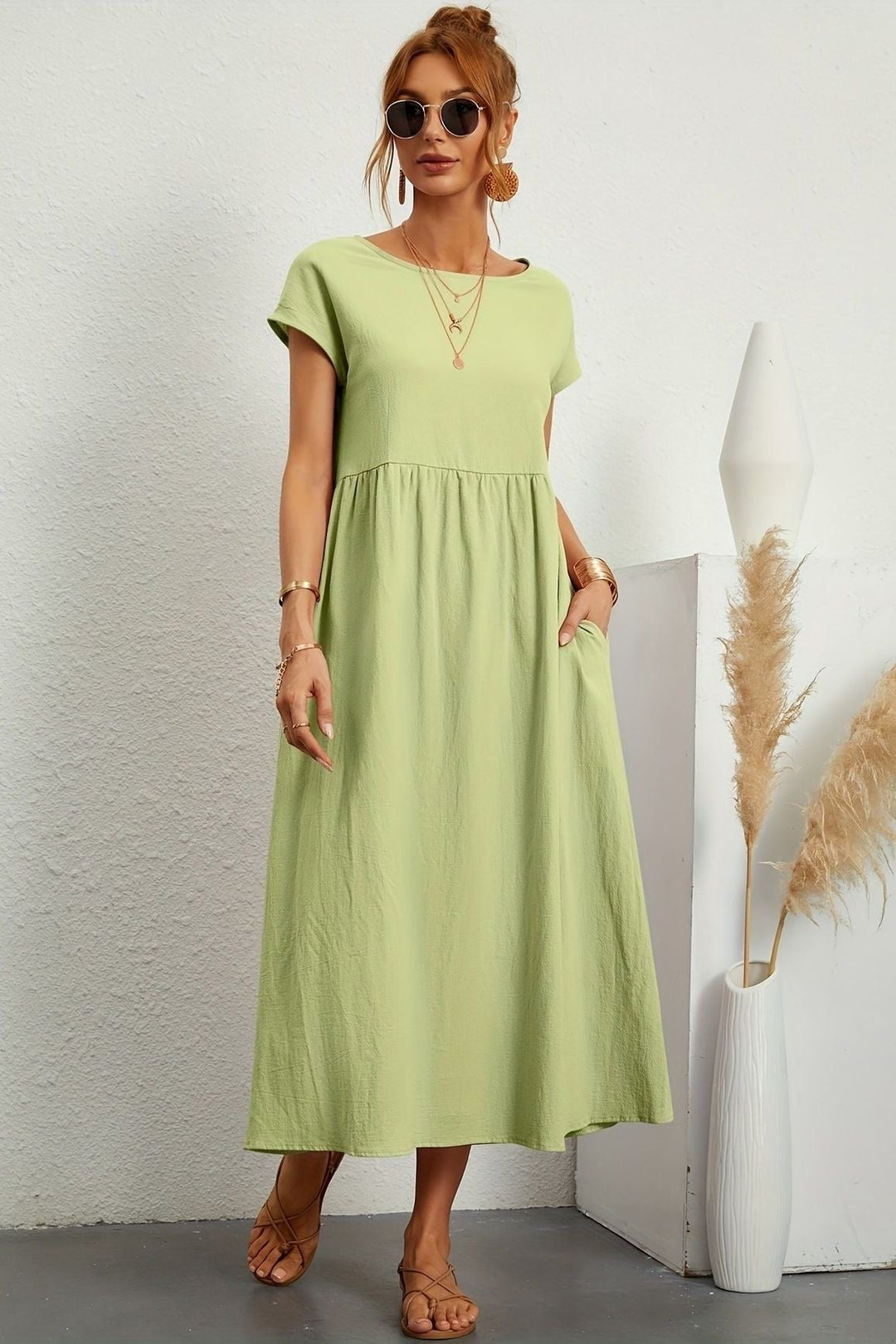 On-trend women's elegant pleated midi dress, versatile for casual spring fashion.
