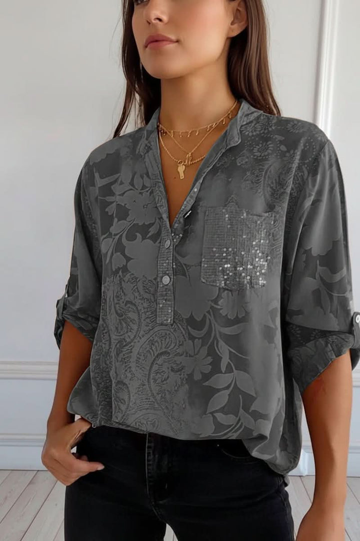 Chic women's printed long sleeve blouse featuring a stylish front pocket. Elegant button-up top for versatile wear.