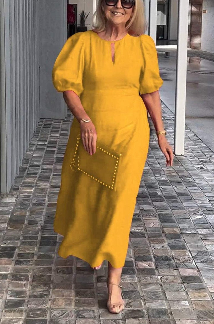Chic women's dress with elegant puff sleeves, a versatile and comfortable midi length for any event.