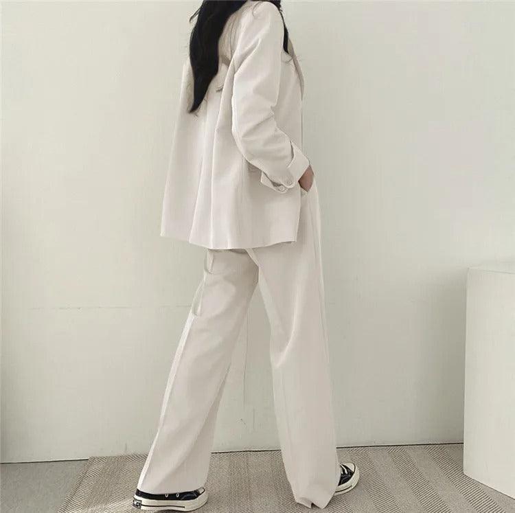 Fashionable women's business wear featuring a long tailored blazer and smart trousers