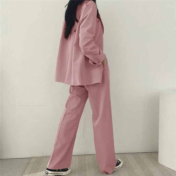Professional women's business wear: elegant long tailored blazer and trouser suit