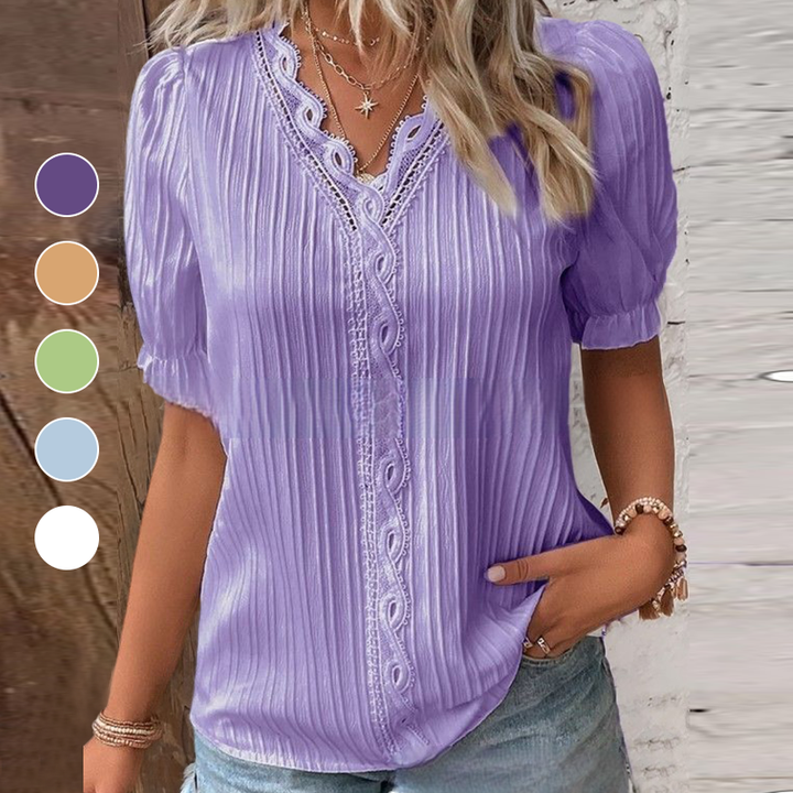 Close-up of the delicate lace trim on a women's V-neck blouse, showcasing elegant details