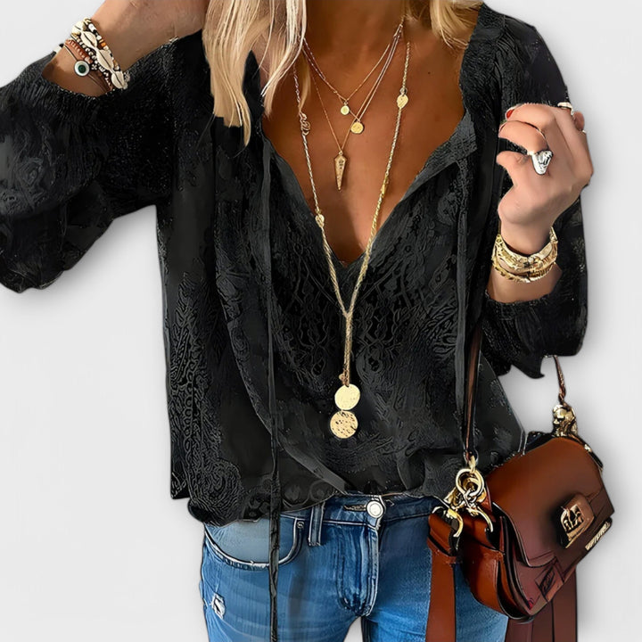 Chic women's V-neck blouse with delicate lace long sleeves, ideal for a feminine and stylish look.