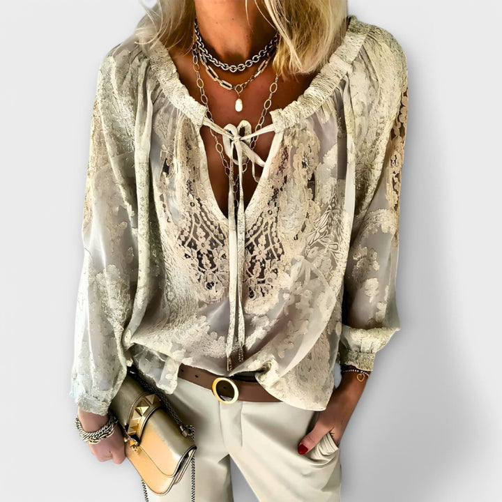 Fashionable women's V-neck lace top. Long sleeves provide comfort & elegance for casual or office wear.