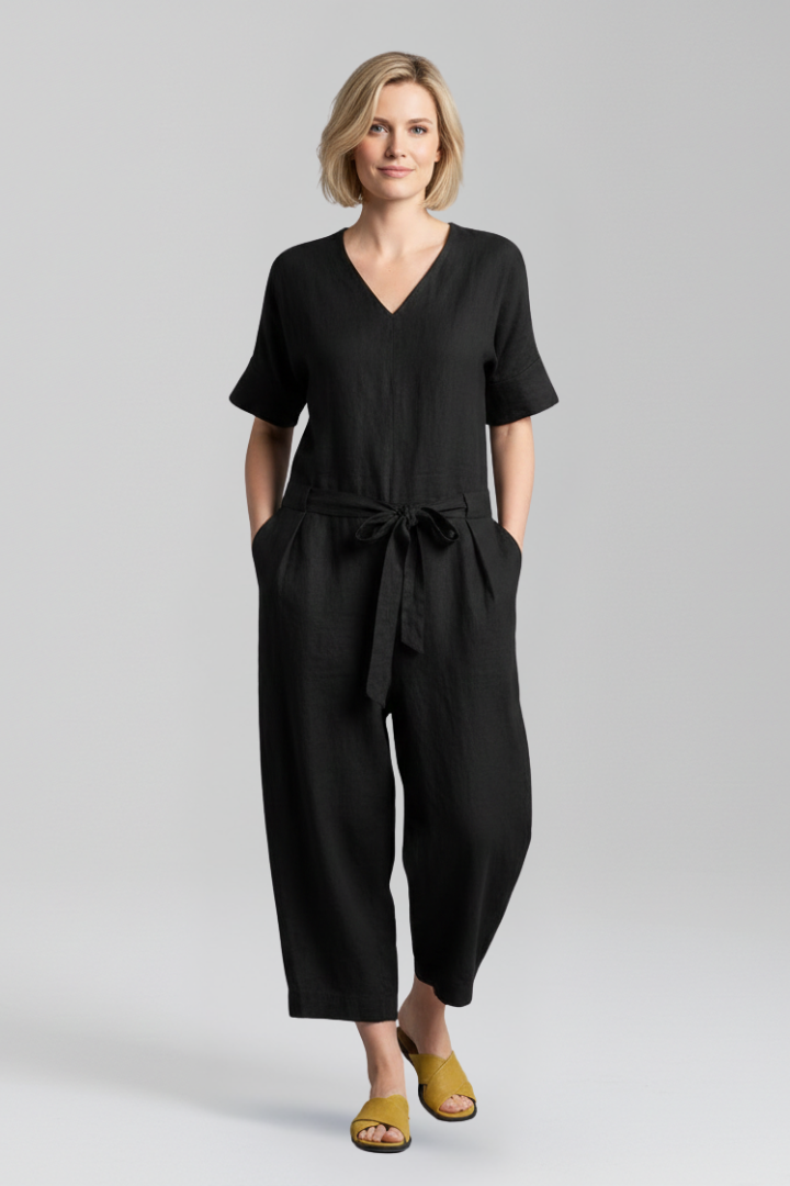 Modern V-neck women's jumpsuit with wide legs and a flattering waist tie, designed for comfort and chic look.
