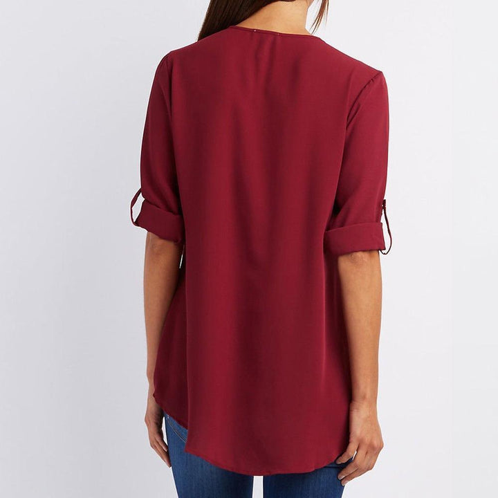 Comfortable women's long sleeve V-neck top with distinct zipper and artistic patchwork design