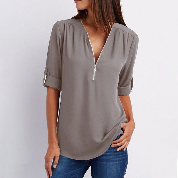 Stylish women's long sleeve V-neck top with zipper and mixed fabric patchwork design