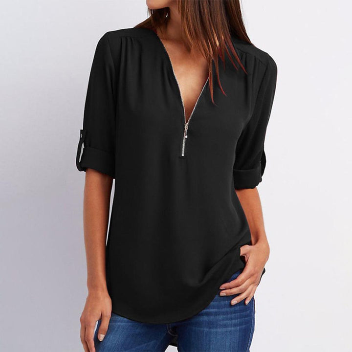 Close-up of a women's V-neck zipper top, highlighting the intricate patchwork design in chiffon