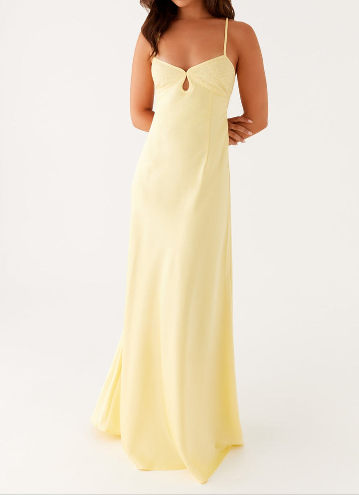 Elegant women's yellow halterneck maxi dress, perfect for summer evenings & special occasions.