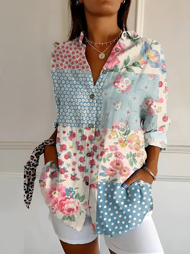 Vibrant printed women's collared blouse, button-front, three-quarter sleeves, ideal for a chic, casual look.